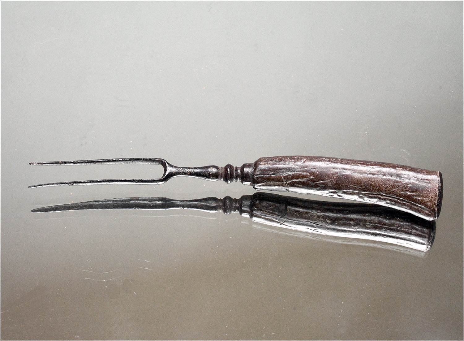 18th century two-pronged fork with bone handle.